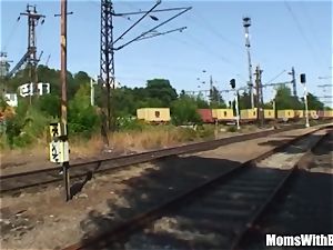 elderly black-haired woman nail Along The train Tracks